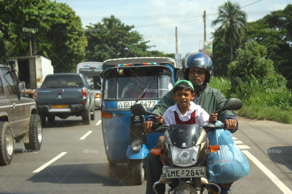 Road Rage at a Young Age. So many people share a bike in Sri Lanka, at times up to 4. Taken July 2010.