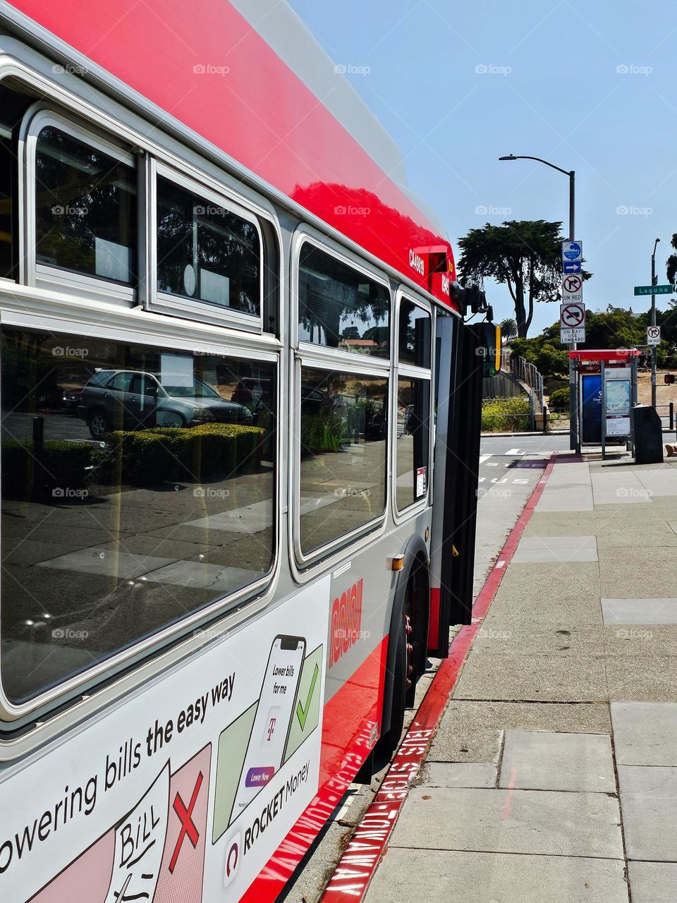 Public transportation bus on the city streets of San Francisco California waiting at the bus stop 