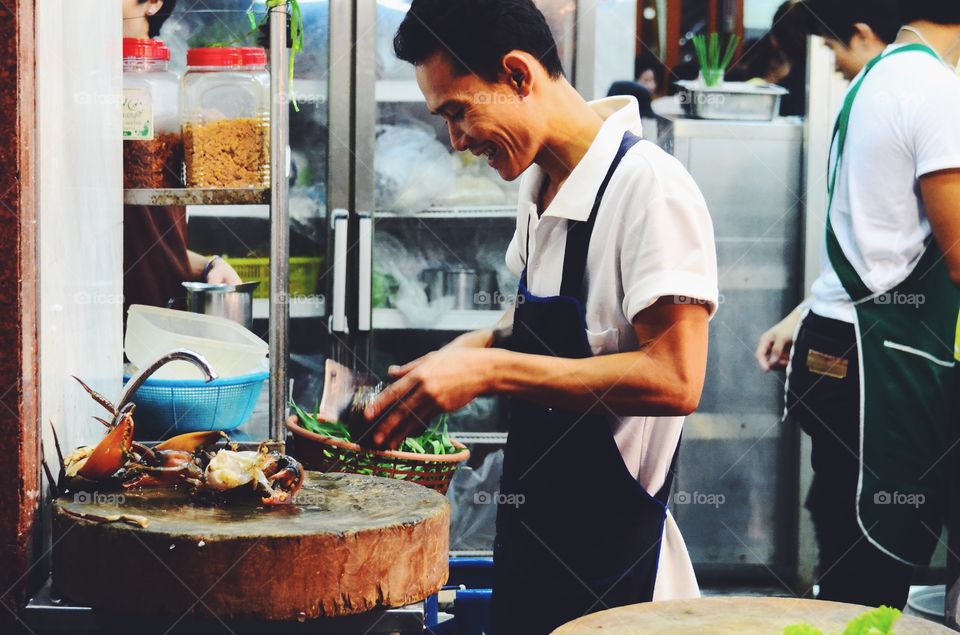 Sea Food. He prepare crab for a good seafood meal.