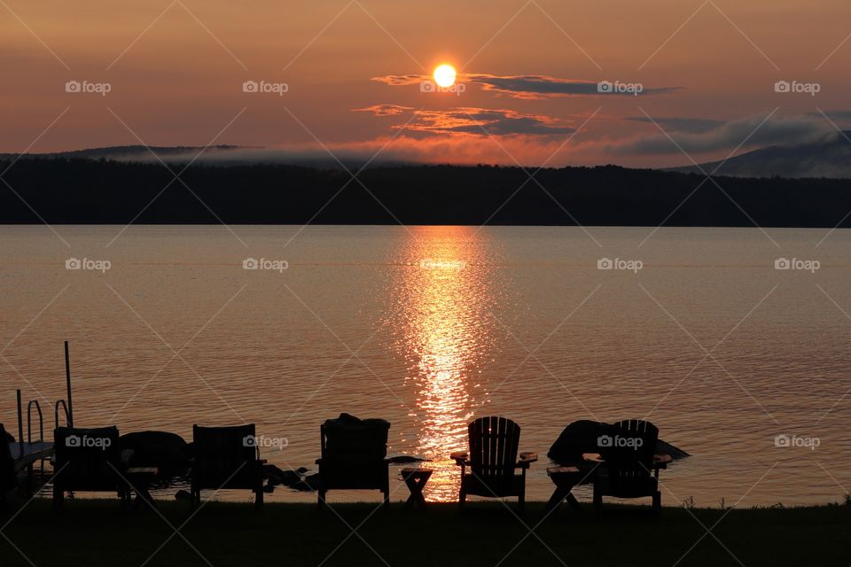 Fiery red sunset at the lake in the Adirondack mountains, 