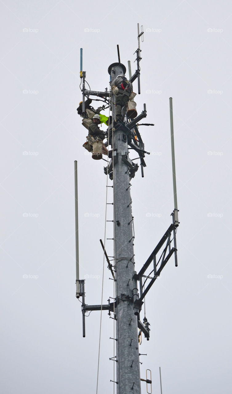 Communications tower climbers repair tower, Augusta, Maine