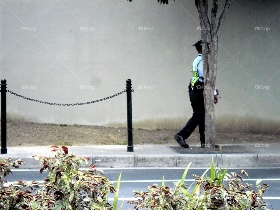 security guard walking along sidewalk