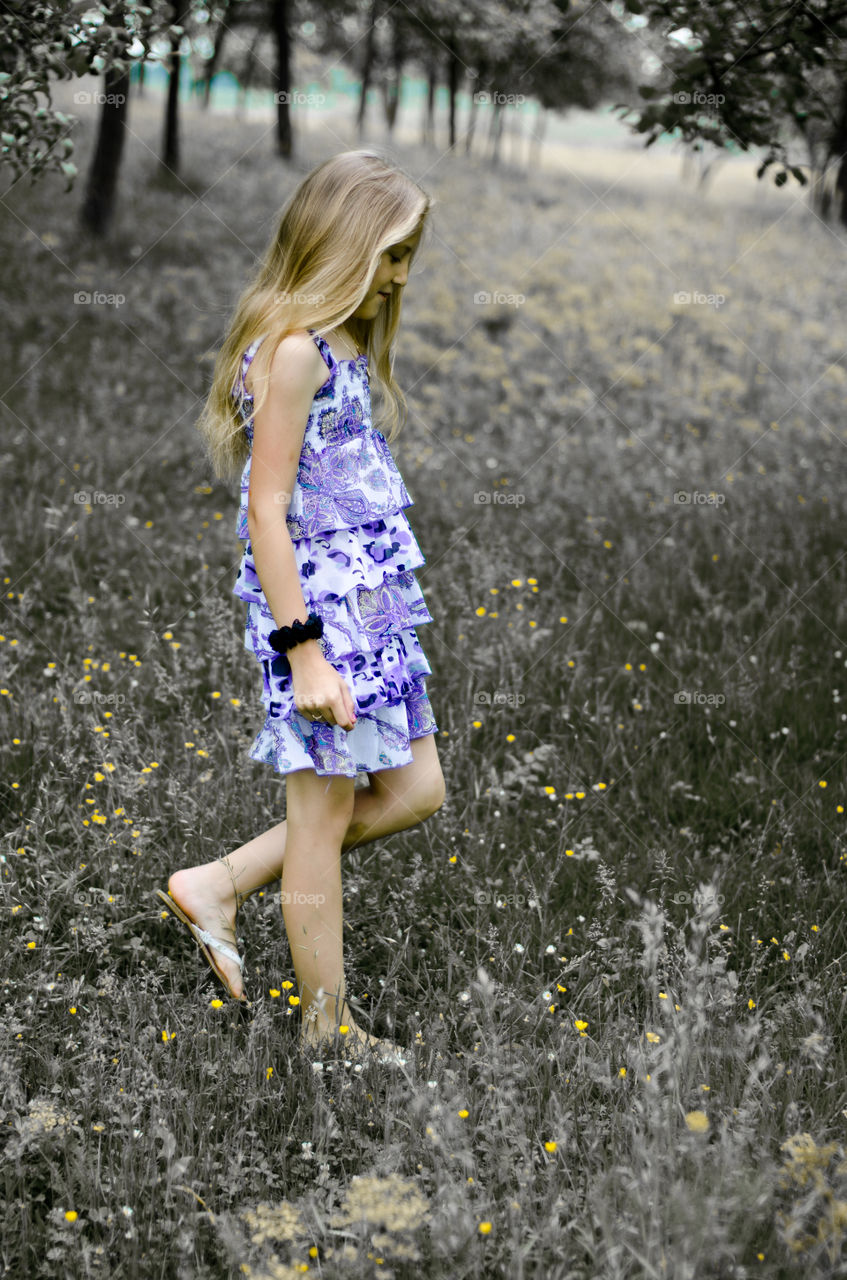 Teenage girl walking in grassy field