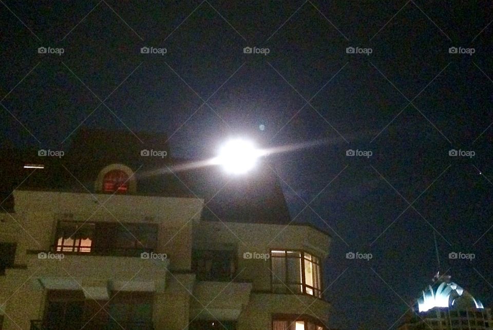 Full moon over roof top