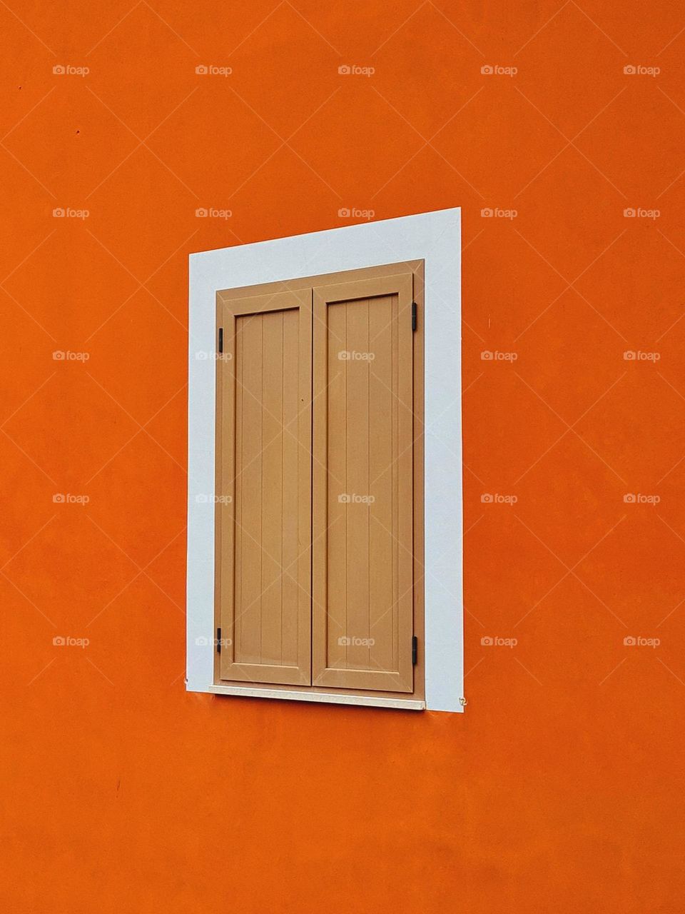 closed window of an orange house