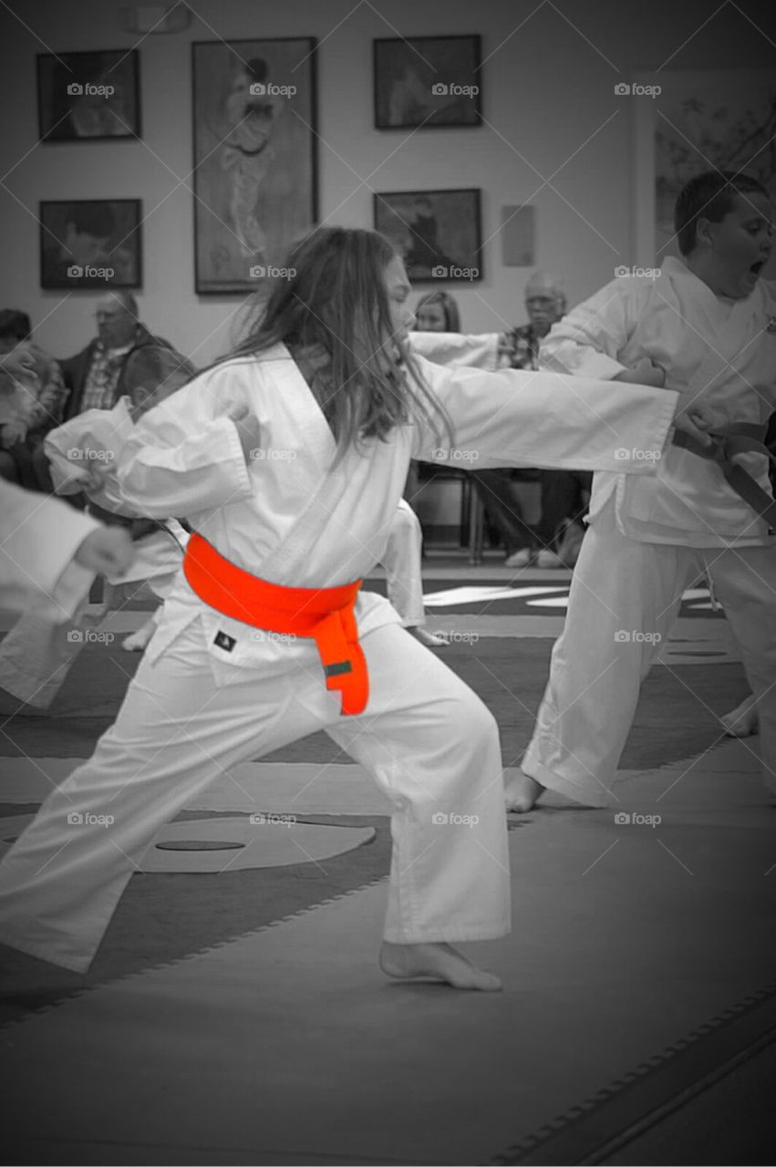 Black and white color effect photo of an Orange belt karate exam. 