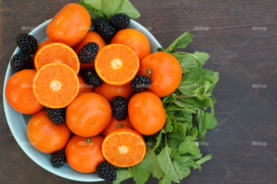 Bowl of fruit with blackberries and oranges