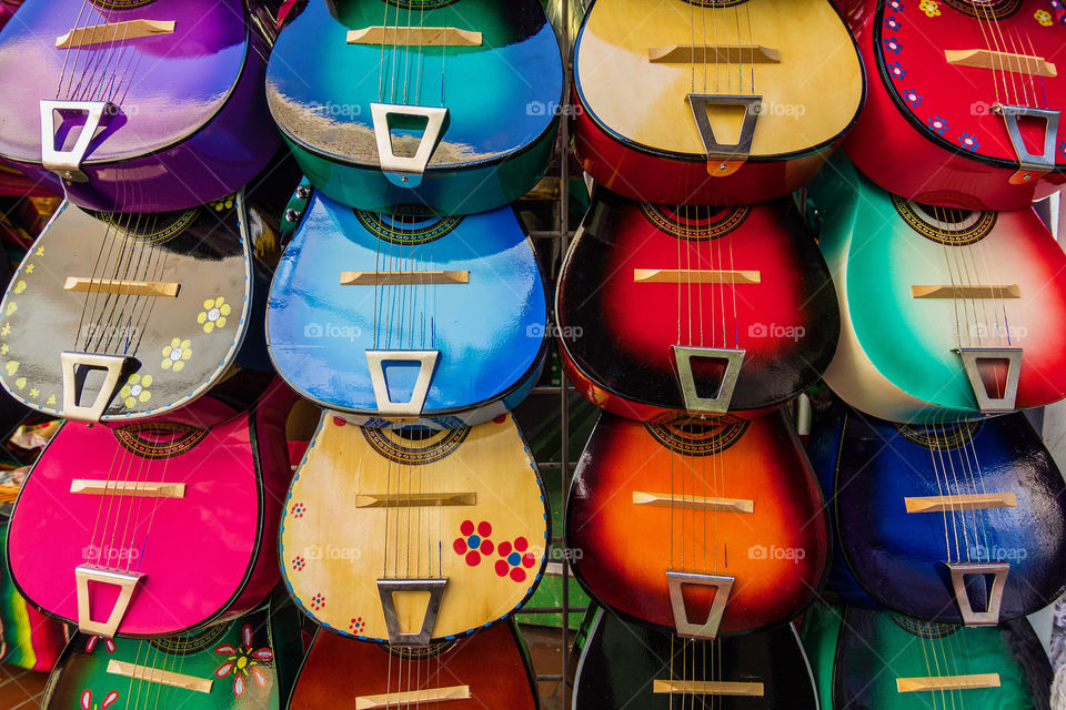 Colorful decorated ukuleles, small guitars, on display on a market stall in downtown LA 