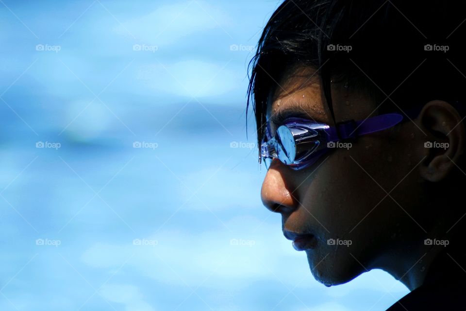a young kid with swimming goggles