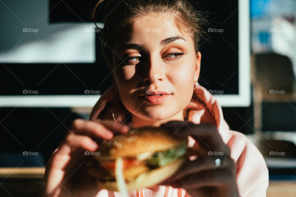 Happy woman ready to eating delicious burger 