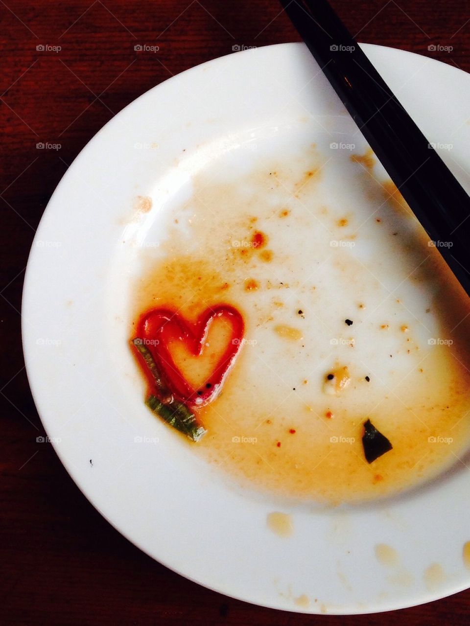 A heart shape and chopsticks on a plate