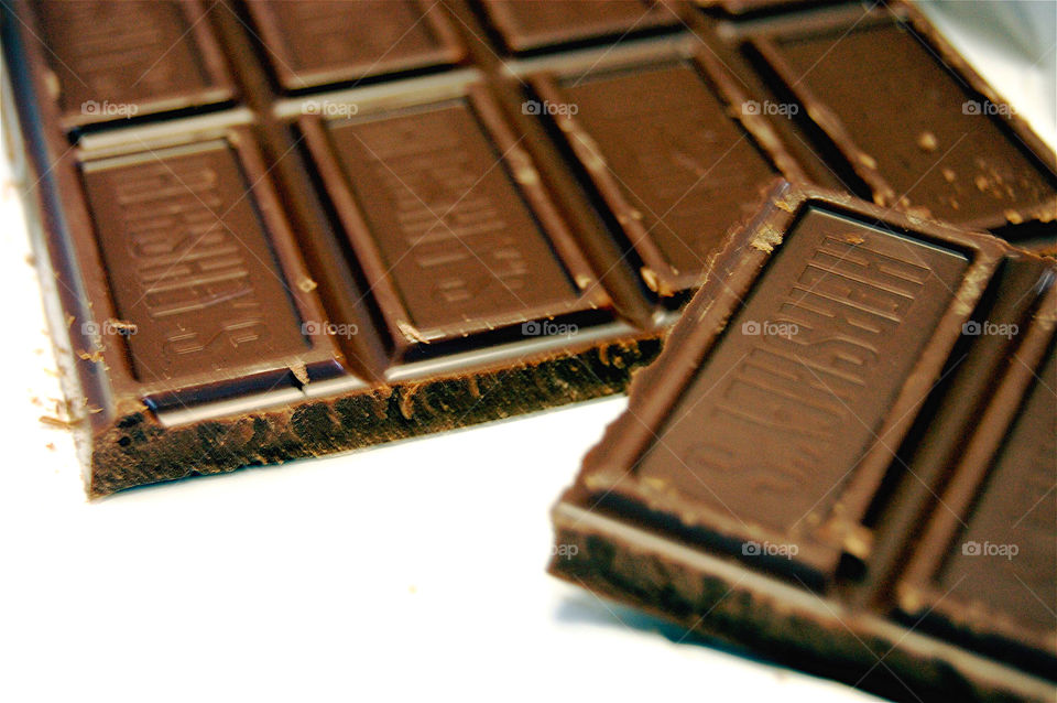 Extreme close up picture of a broken, chocolate, candy bar. 