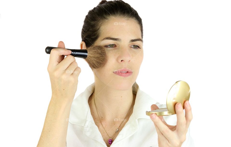 Woman applying make up