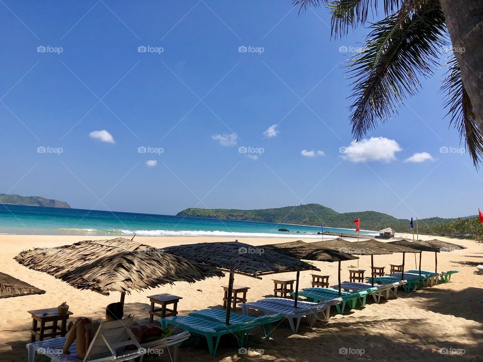 Beach huts along the white sand beach