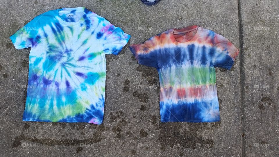 tie dye t shirts on sidewalk