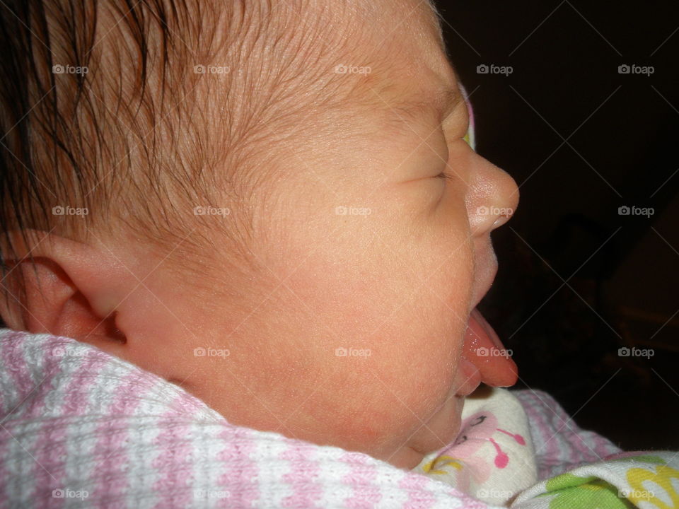 Baby Blah!!. Young baby, profile with tongue out. 