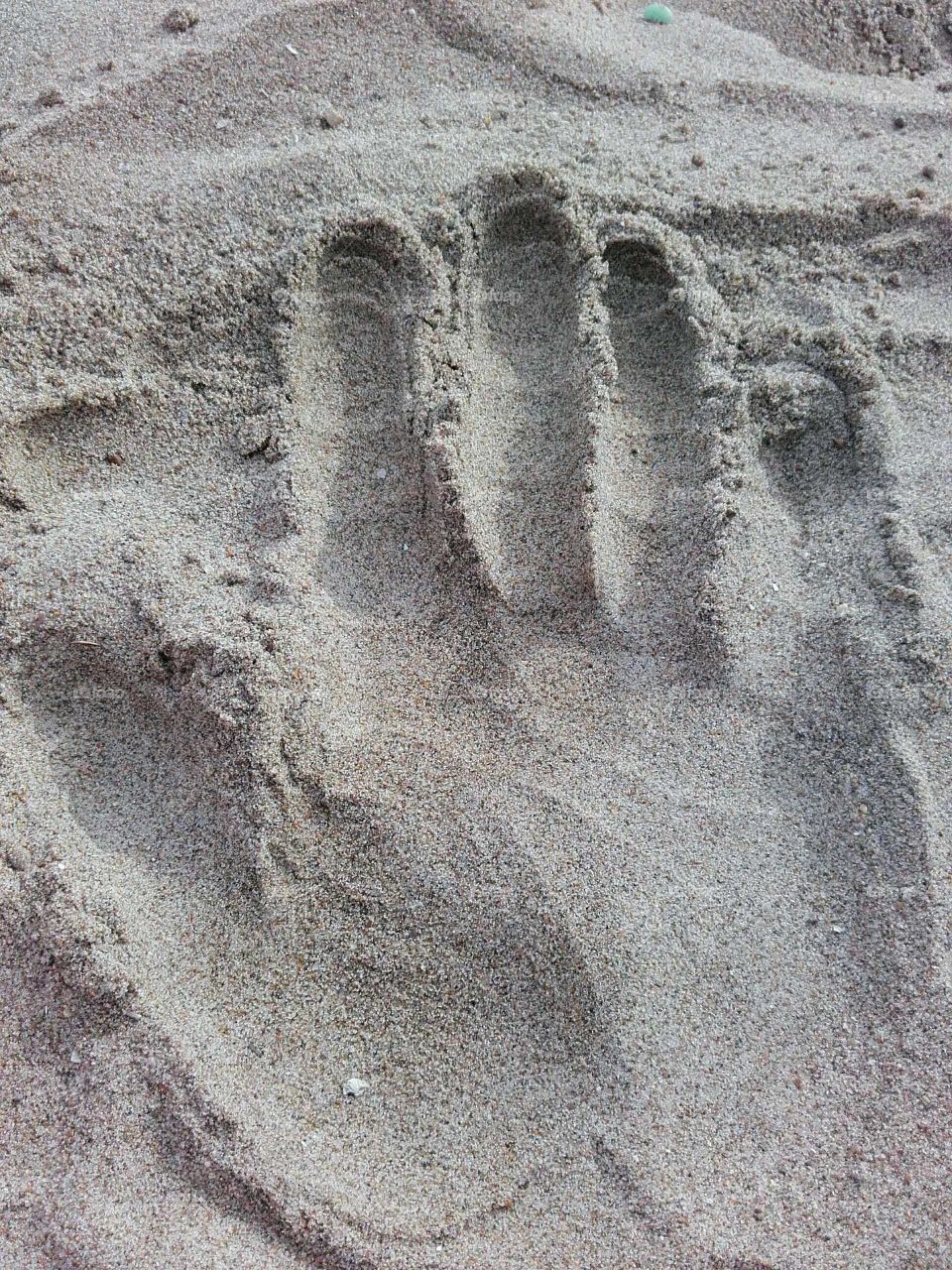 Hand in sand