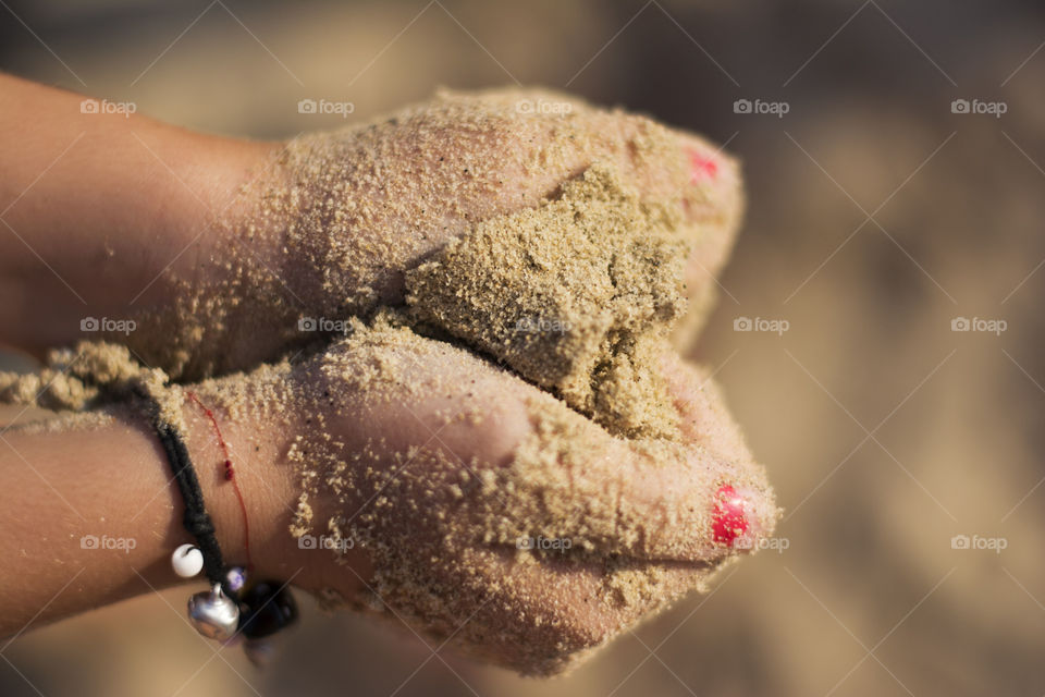 heart of sand. child hands making heart shape of sand