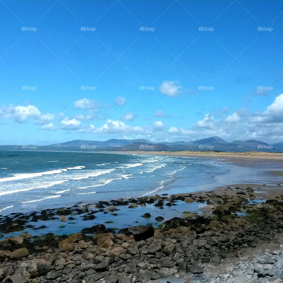 I love the Welsh coastline with the mountains in the background and blue skies.