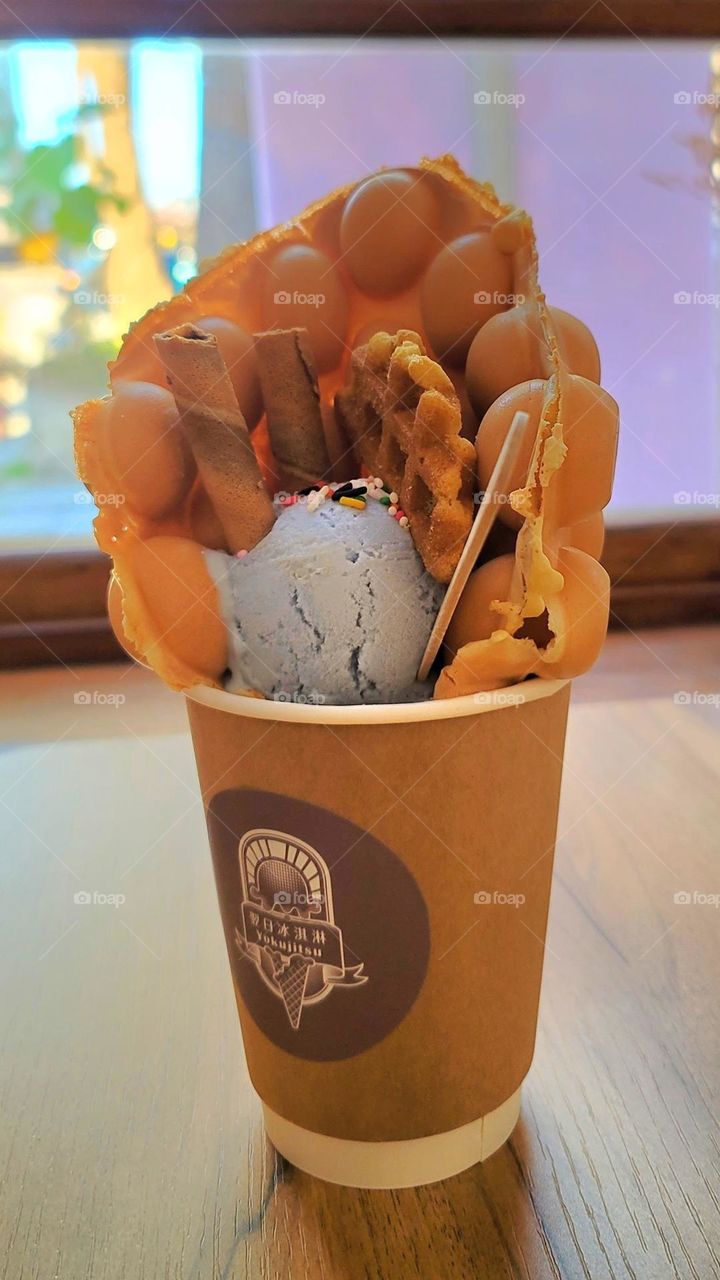 Hong Kong egg waffles with checkered pancakes, wafer roll ,and Sprinkles and blue ice cream