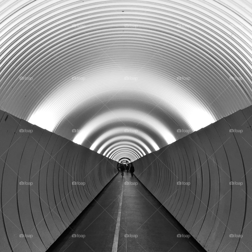 Silhouette of people in tunnel