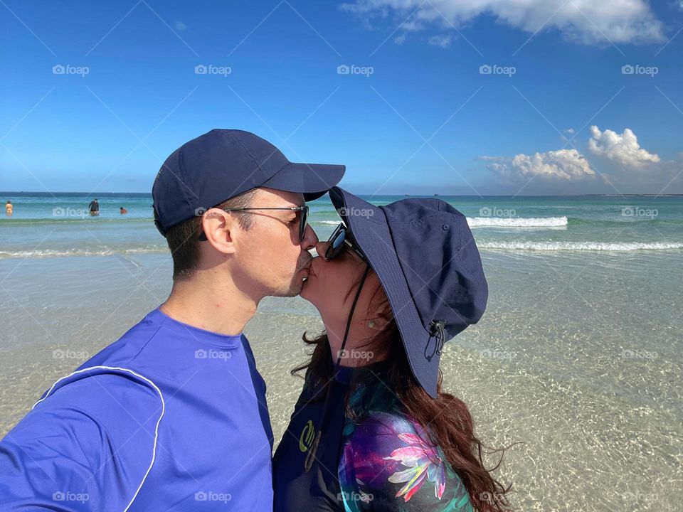 A couple on the beach celebrating summer