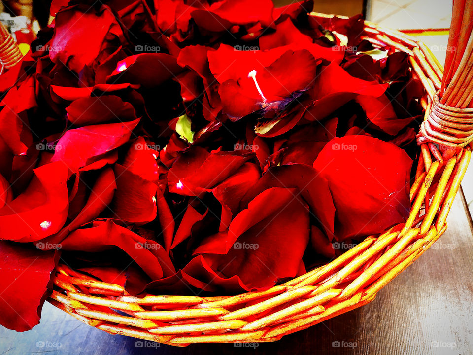 Basket with red rose petals