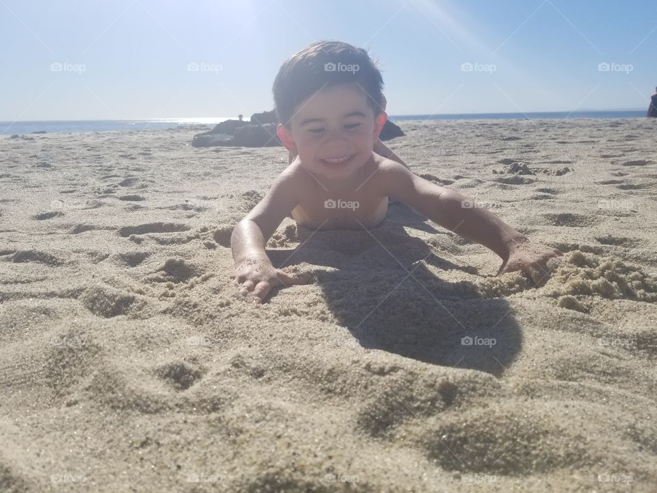 laying in the sand