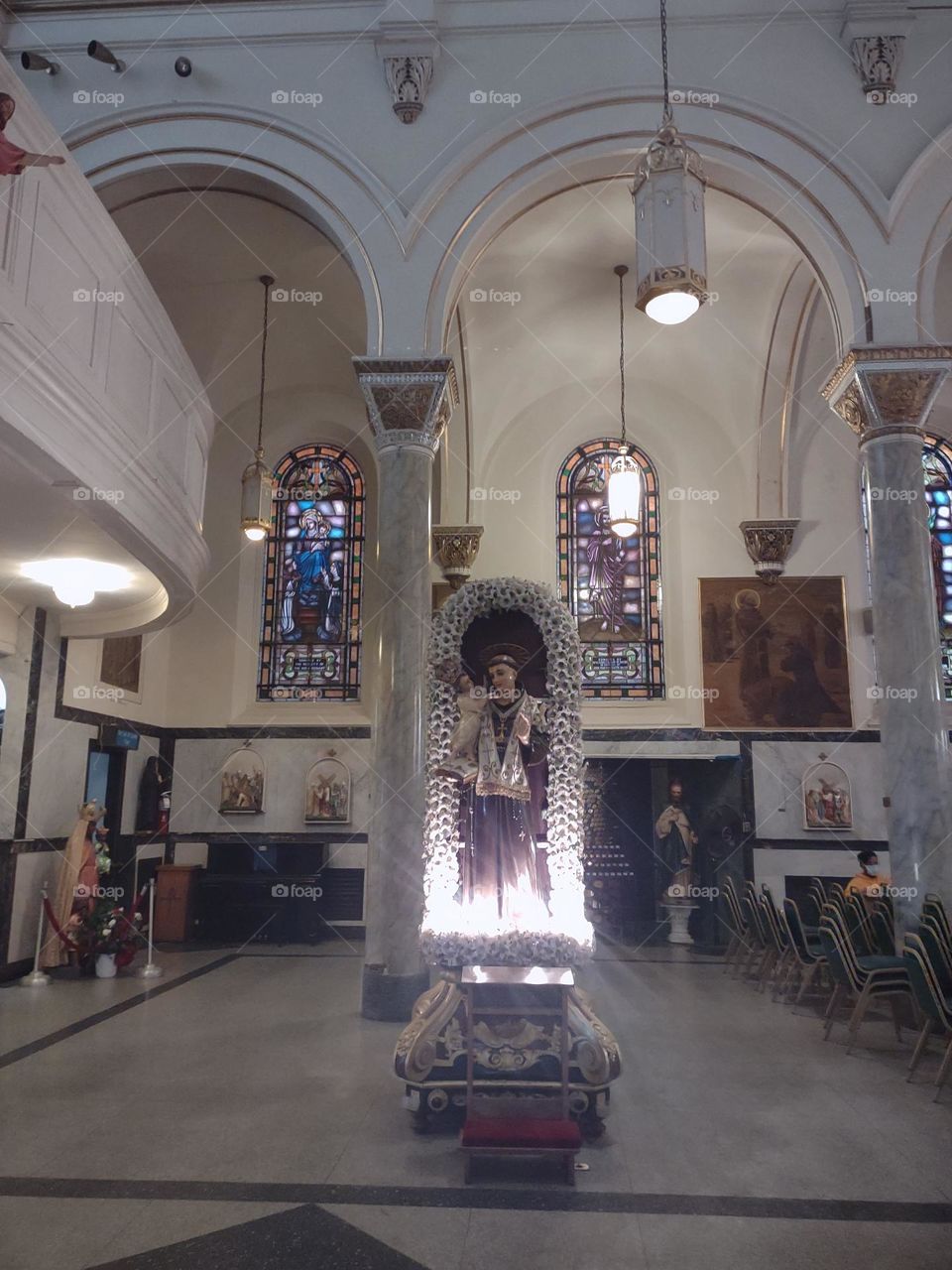 Statue of the Virgin Mary in it's own niche. This one is adorned with electric lights.