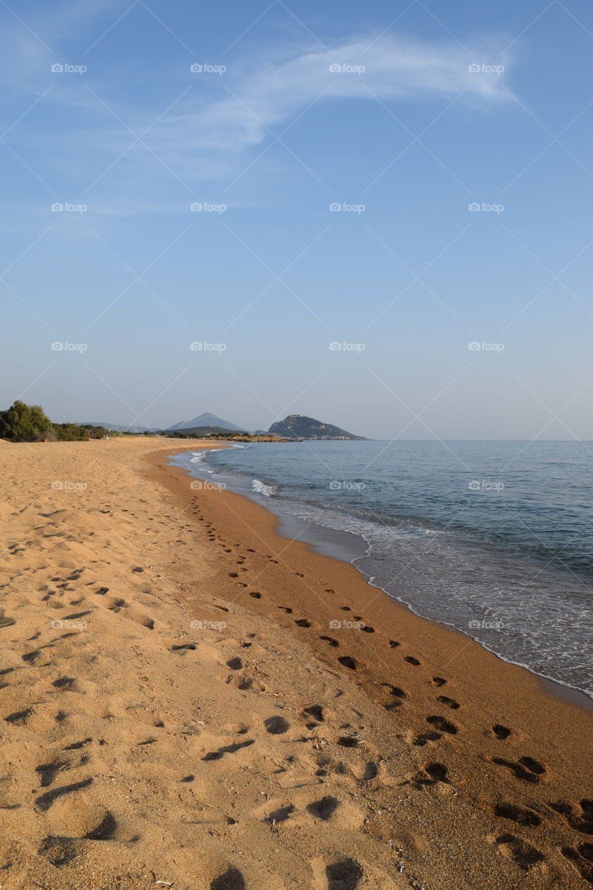 Scenic view of  beach against blue sky