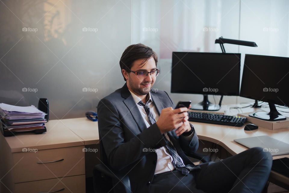 Young businessman using phone