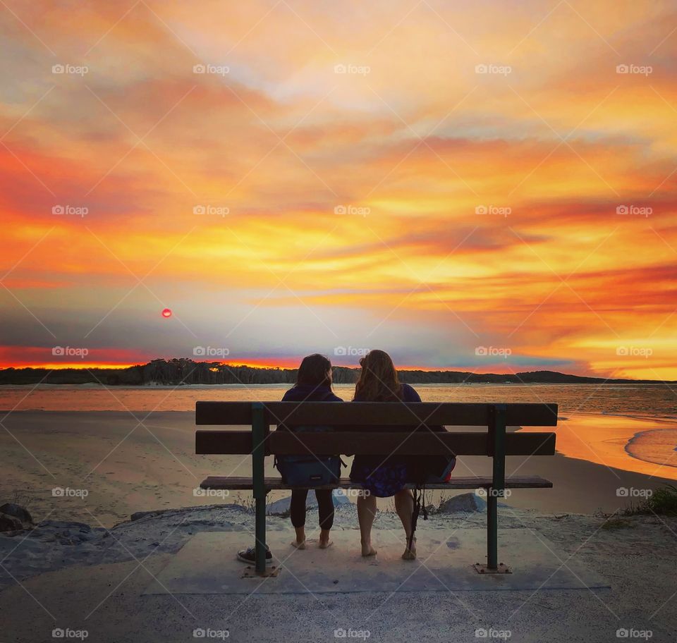 Watching the sunset At the ocean 