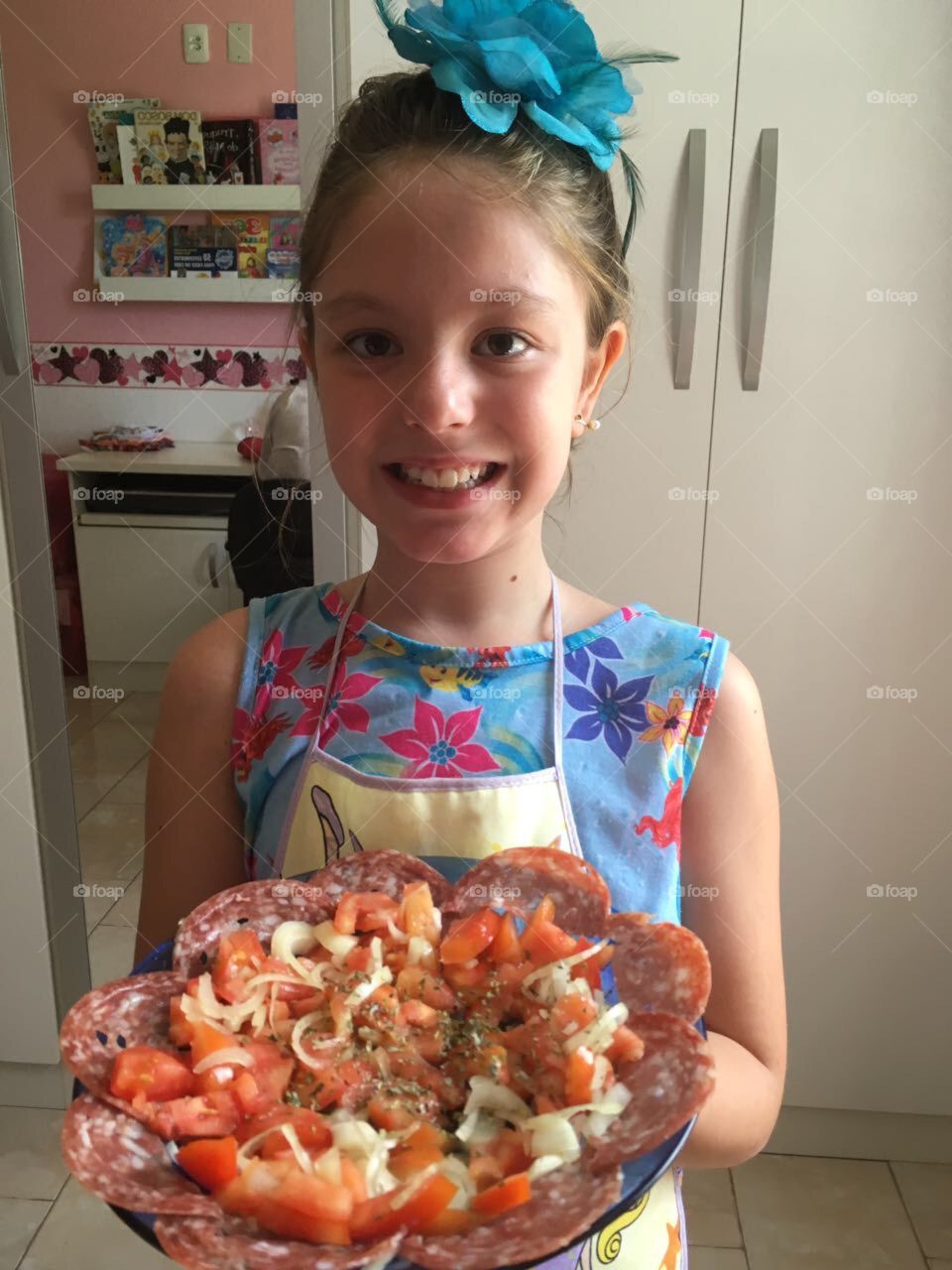 Smiling girl holding delicious food on plate