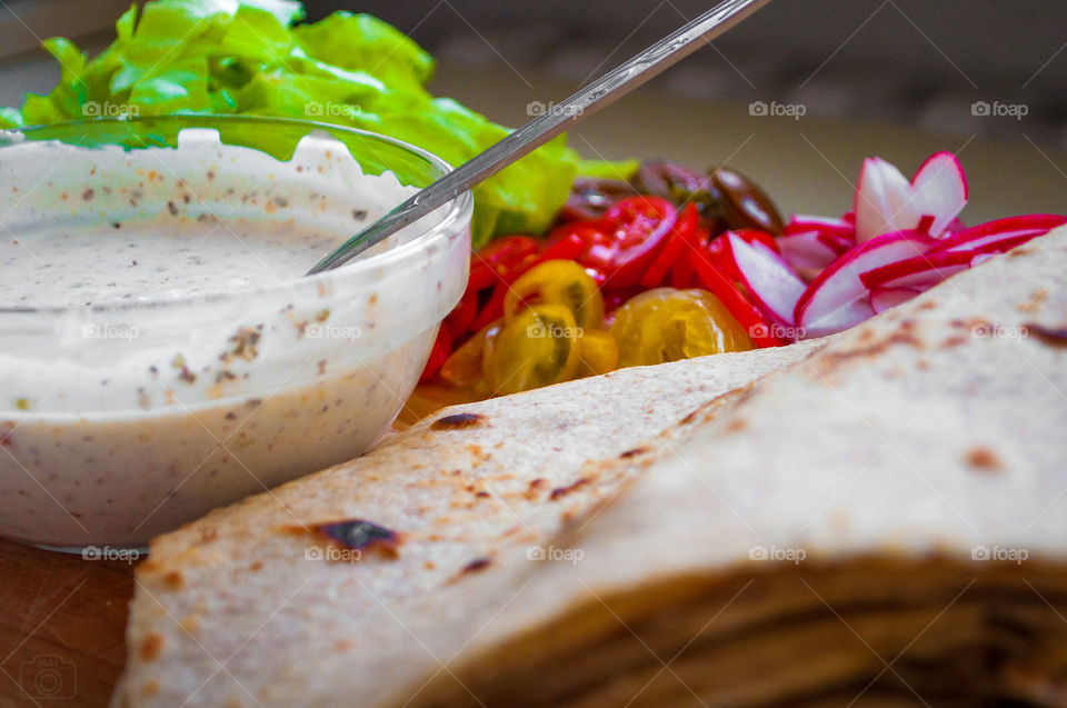 Tortilla witch vegetables meat and sauce