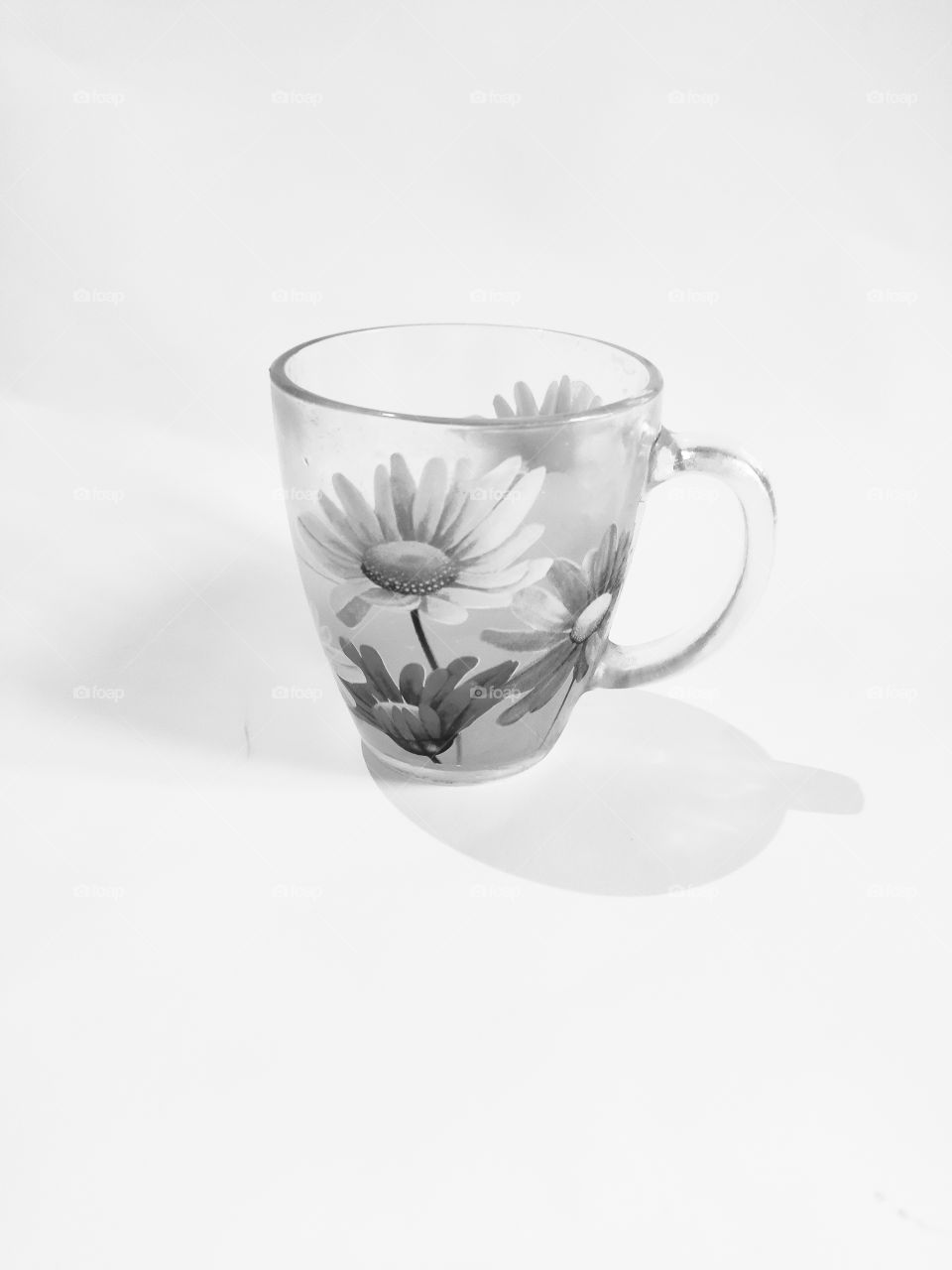 On a white background, a cup in black and white retro photo