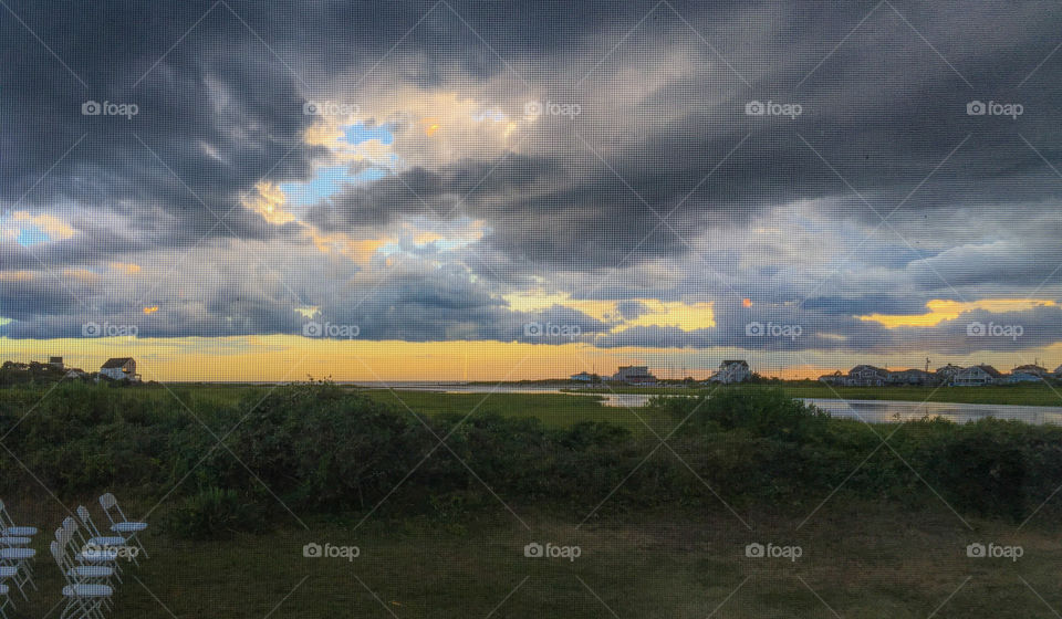A beautiful view from my dinner table one night. The outside lawn had been set with chairs for an earlier function, too bad they missed this sunset