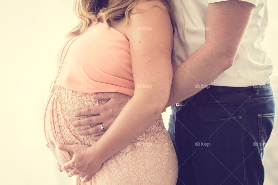 Pregnant couple pink dress