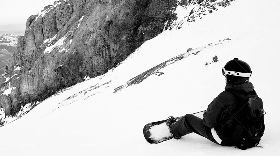 Snowboarder resting on the off-piste in Titlis, Switzerland