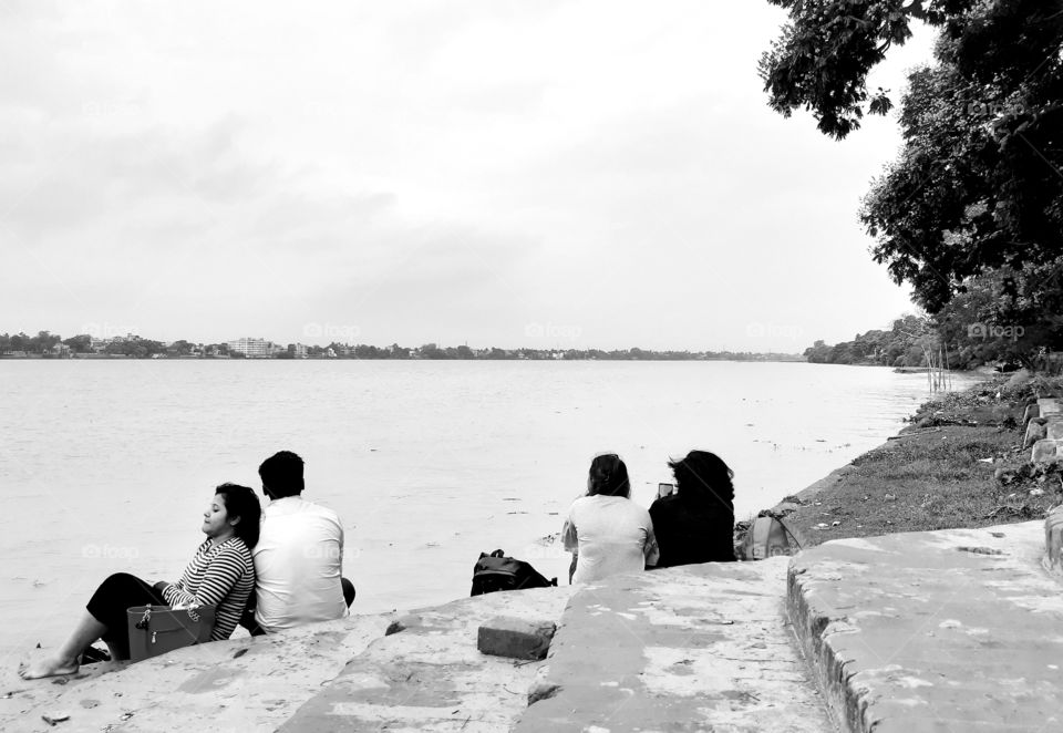 couple sitting at riverbank