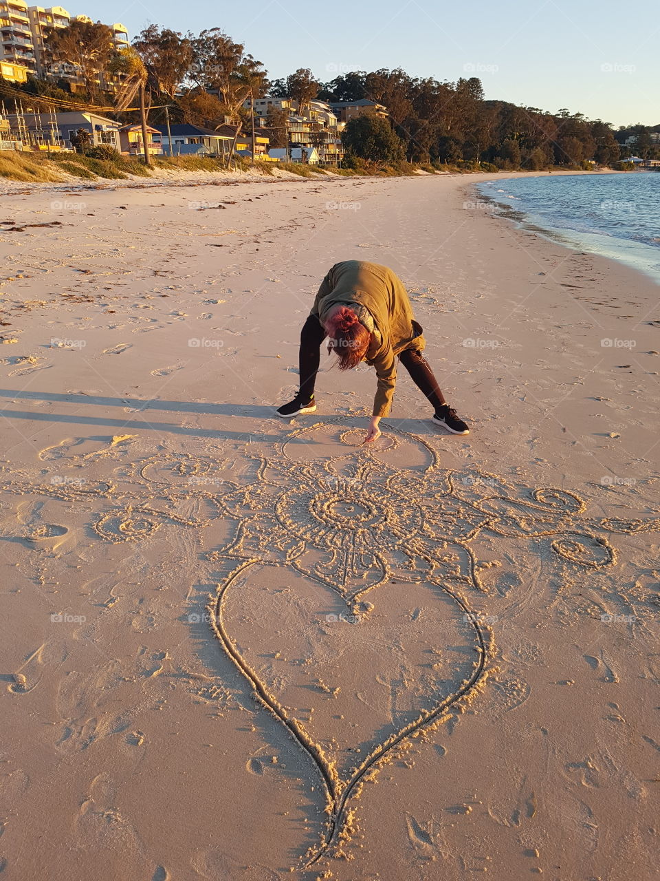 Mandala artist on the Beach