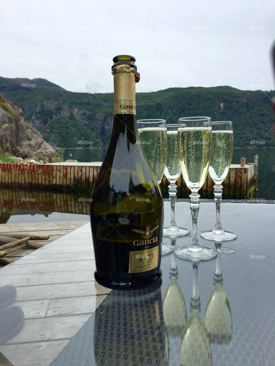 Champagne in the fjords. Champagne and glasses in the nature. 