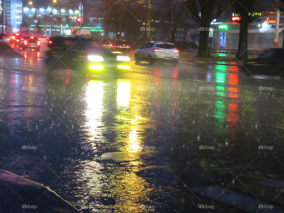 rainy evening in the city, road with cars, wet