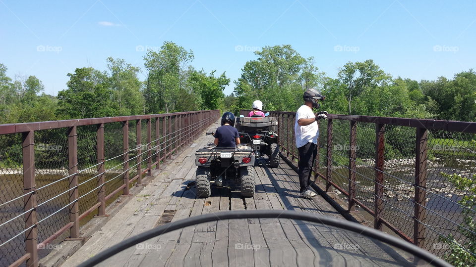 ATV trail ride rest stop on a bridge over a river