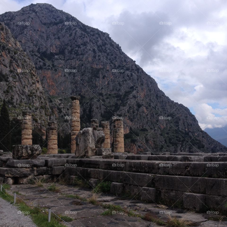 Rock formation against cloudy sky