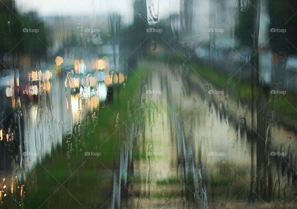 Raining outdoor, wet window background and railway in the city