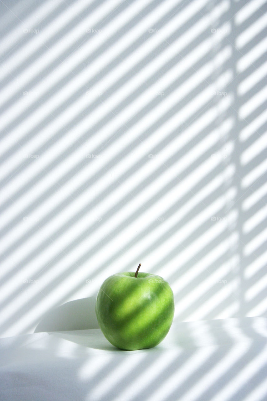 Shadow play with green apple