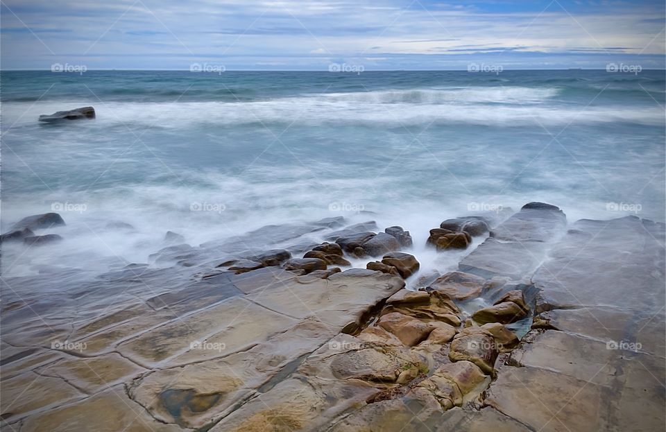 Waves over rocks. Merewether Beach, NSW Australia 