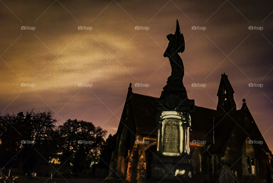 Midnight at the cemetery, moody skies creating emphasis on the silhouettes.