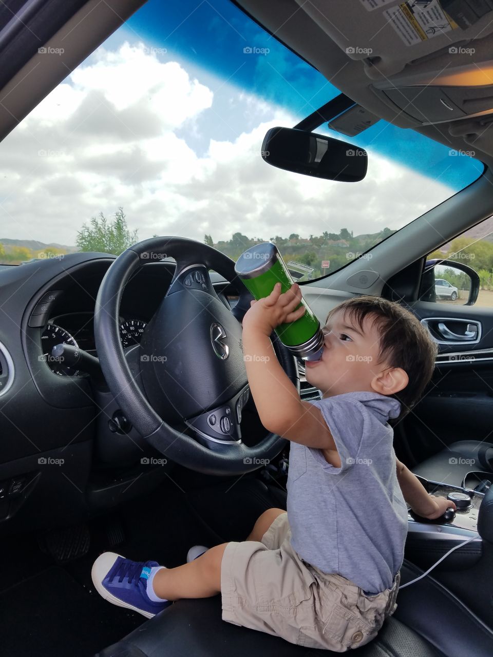 Little boy drinking water from bottle