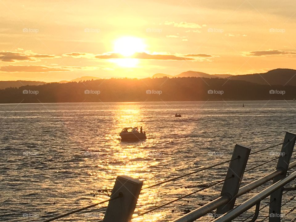 Silhouette of a ship in sea during sunset